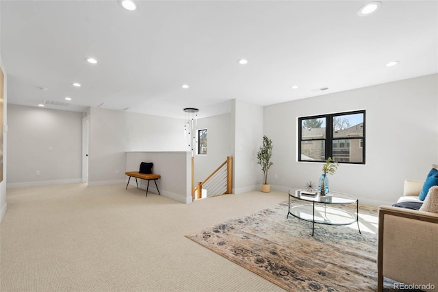 carpeted living area featuring recessed lighting, visible vents, and baseboards