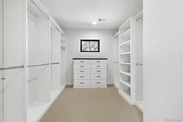 walk in closet featuring light carpet and visible vents