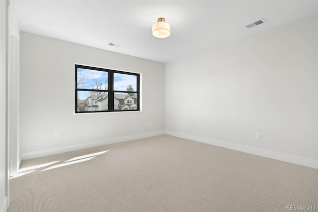 unfurnished room with baseboards, visible vents, and carpet flooring
