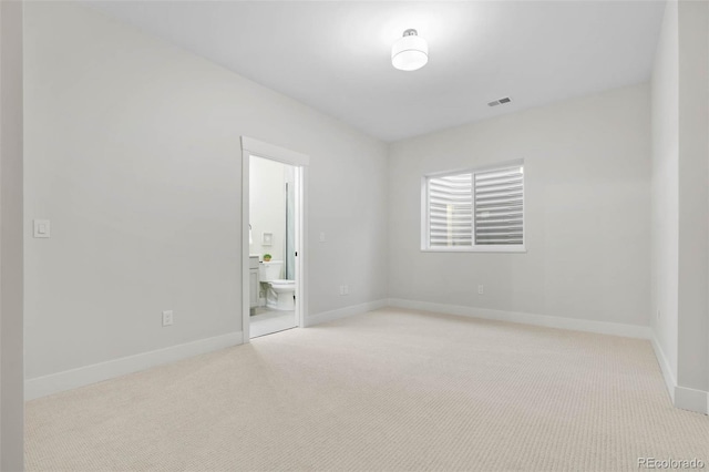 spare room with baseboards, carpet flooring, and visible vents