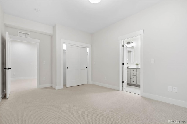 unfurnished bedroom with light colored carpet, baseboards, visible vents, and a closet