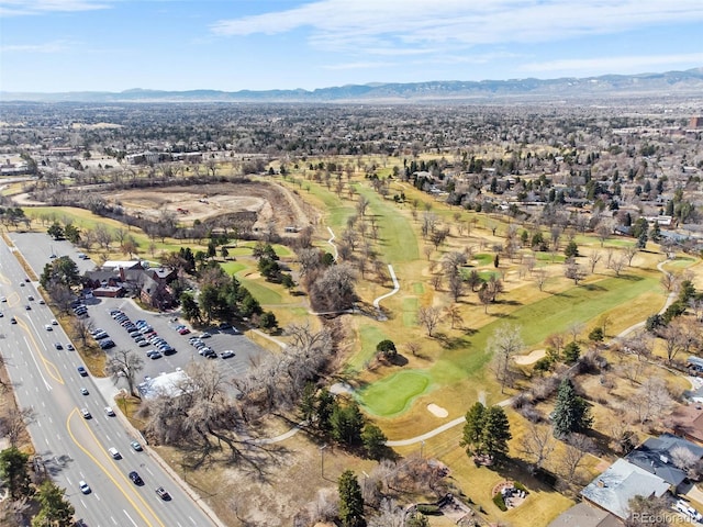 drone / aerial view featuring a mountain view, golf course view, and a residential view