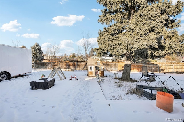 yard layered in snow with a playground