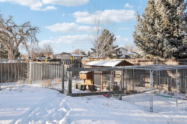 yard layered in snow with an outdoor structure