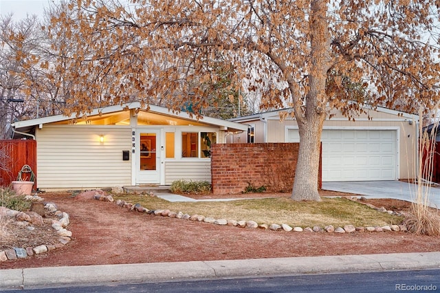 mid-century home with fence and driveway