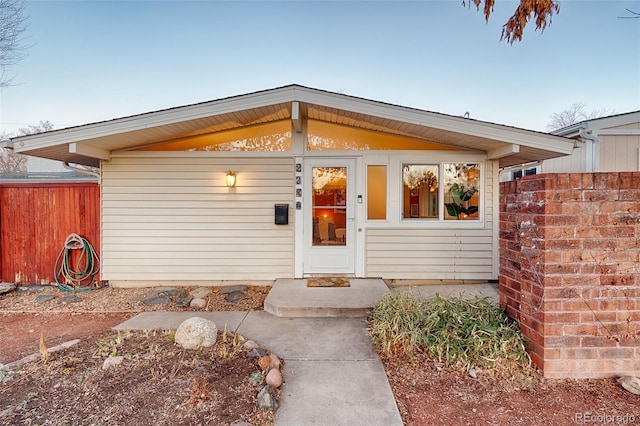 view of front of home featuring fence