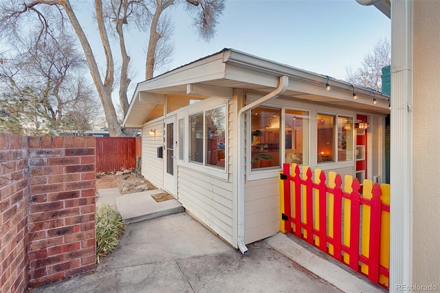 view of side of home featuring fence