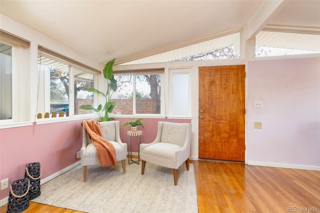 sunroom featuring lofted ceiling with beams