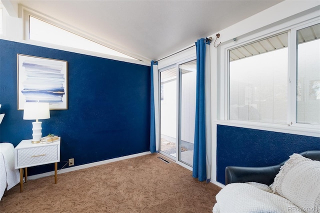 sitting room featuring lofted ceiling, carpet floors, visible vents, and baseboards