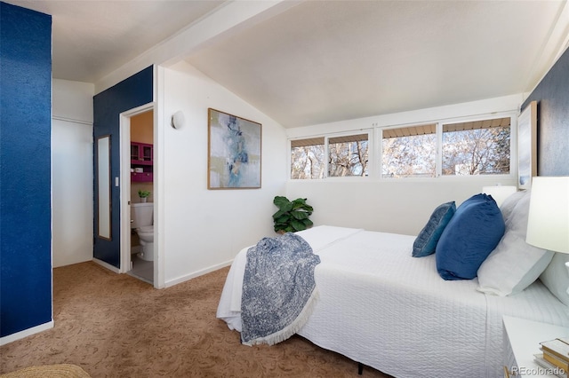 carpeted bedroom with lofted ceiling, baseboards, and ensuite bathroom