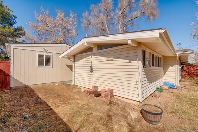 view of side of home with fence