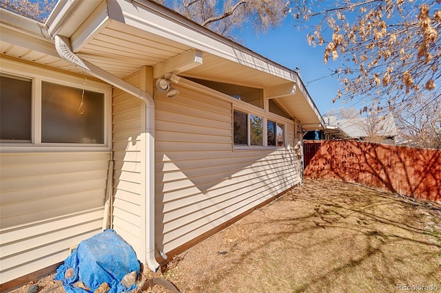 view of home's exterior with fence