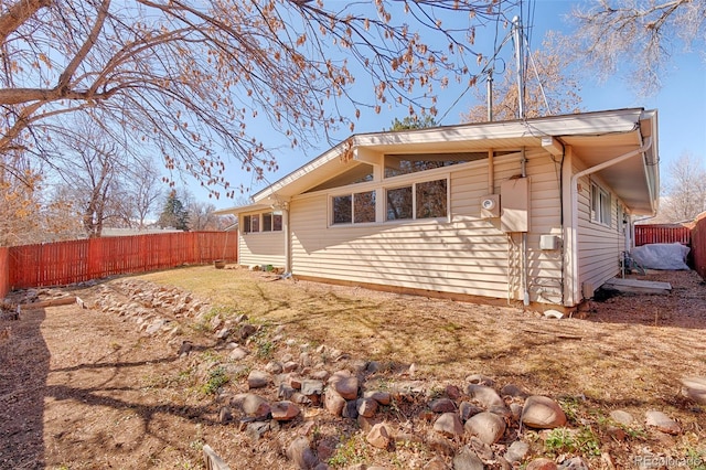 back of property with a fenced backyard