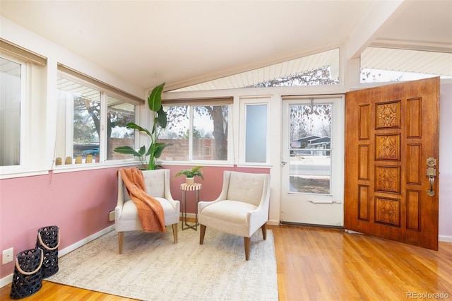 sunroom with vaulted ceiling with beams