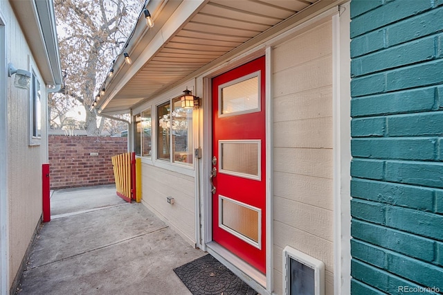 view of exterior entry featuring fence