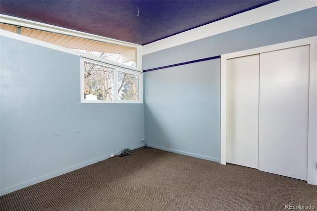 unfurnished bedroom with carpet flooring and baseboards