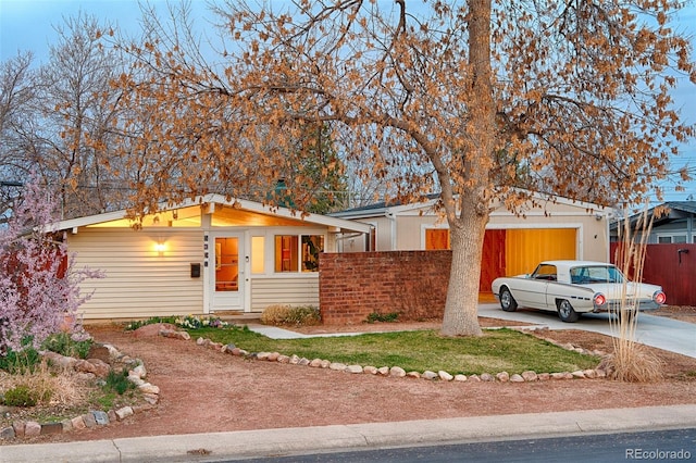 2370 S Meade St, Denver, CO 80219 - view of front of house featuring concrete driveway, fence, and a garage