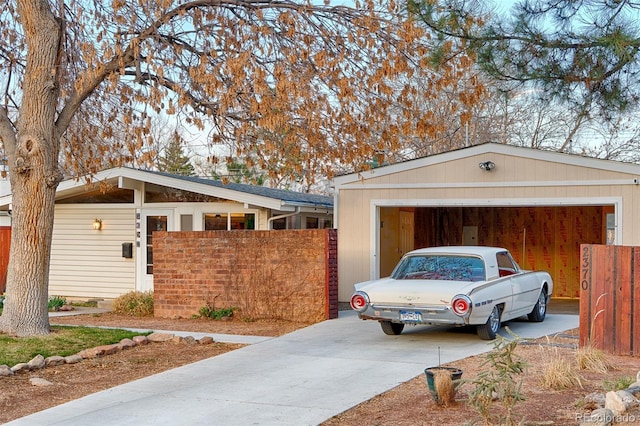 2370 S Meade St, Denver, CO 80219 - view of side of property featuring a garage, concrete driveway, and fence