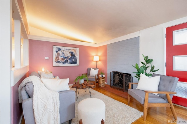 2370 S Meade St, Denver, CO 80219 - living room featuring light wood-type flooring and a brick fireplace