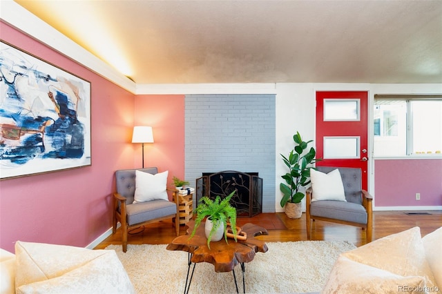 2370 S Meade St, Denver, CO 80219 - living area with a fireplace, wood finished floors, and baseboards