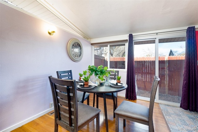2370 S Meade St, Denver, CO 80219 - dining room with baseboards, wood finished floors, and vaulted ceiling