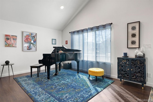 living area with lofted ceiling, wood finished floors, and baseboards