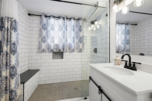 bathroom featuring vanity and a tile shower