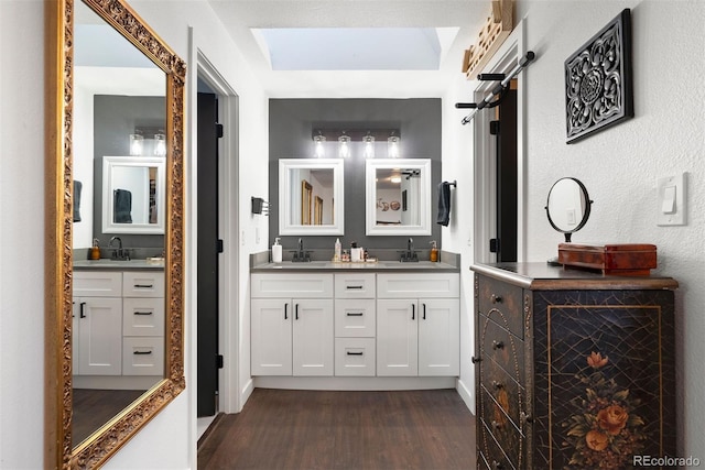 full bathroom featuring a sink, wood finished floors, and double vanity