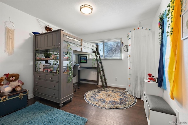 bedroom featuring wood finished floors and baseboards