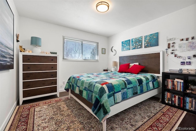 bedroom featuring baseboards and wood finished floors