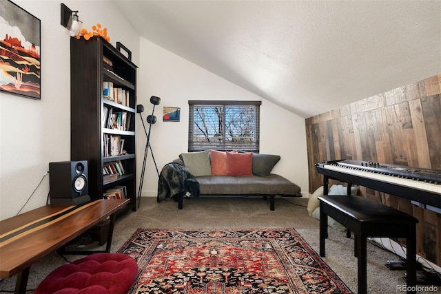 office with vaulted ceiling, wooden walls, carpet, and a textured ceiling