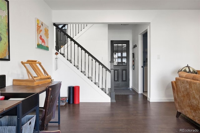 entrance foyer with baseboards, wood finished floors, and stairs