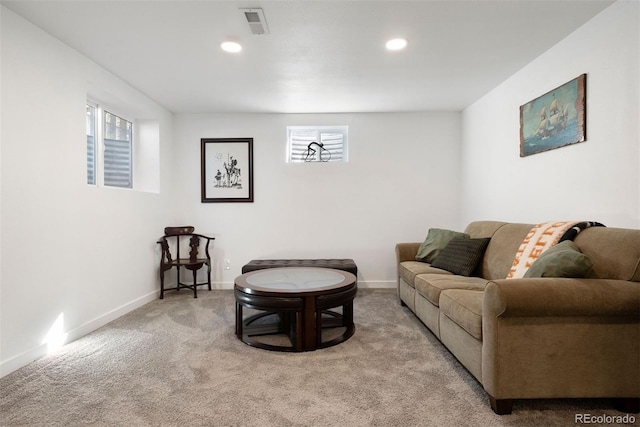 carpeted living area featuring recessed lighting, visible vents, and baseboards