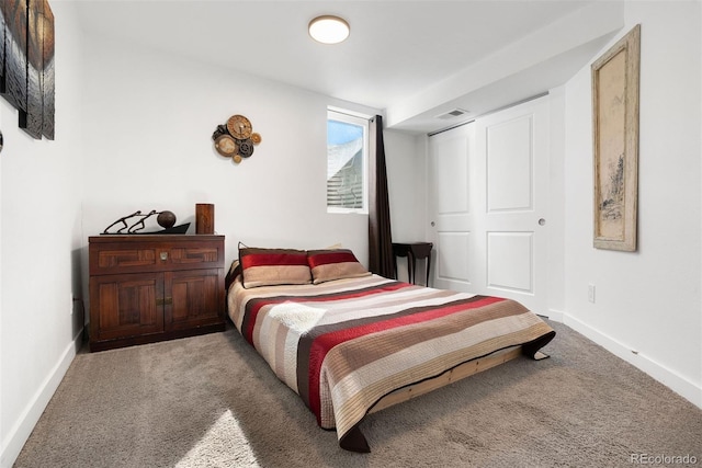 bedroom featuring visible vents, baseboards, and carpet