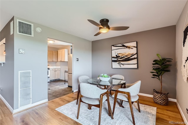 dining room featuring ceiling fan and light hardwood / wood-style flooring