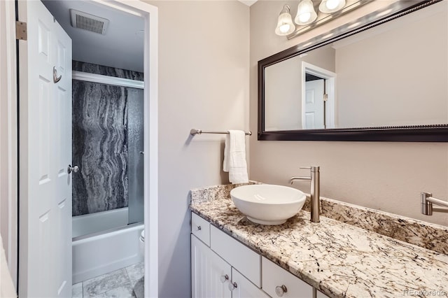 bathroom featuring shower / bath combination with glass door, vanity, and tile patterned flooring