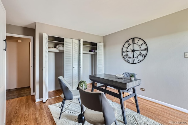 office space with wood finished floors and baseboards