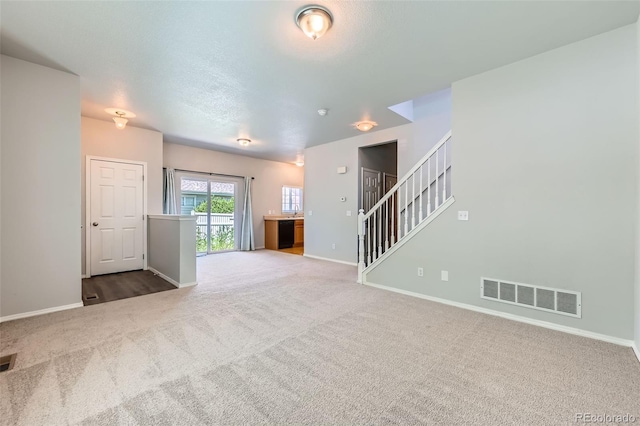 1389 S Quintero Way, Aurora, CO 80017 - unfurnished living room featuring carpet flooring and stairs