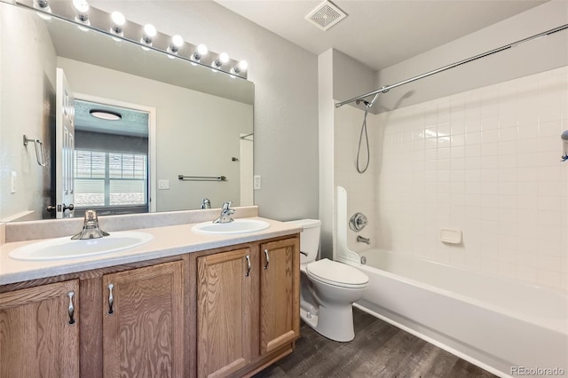 1389 S Quintero Way, Aurora, CO 80017 - full bathroom with double vanity, wood finished floors, and bathing tub / shower combination