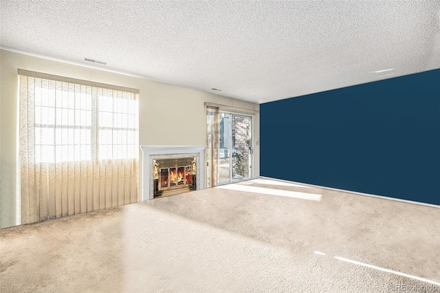 unfurnished living room with a wealth of natural light and a textured ceiling