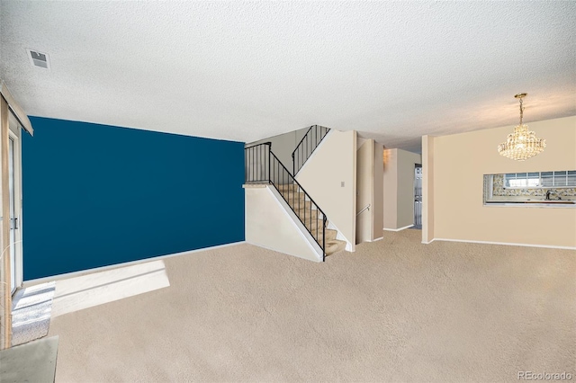 unfurnished room with sink, a chandelier, carpet flooring, and a textured ceiling