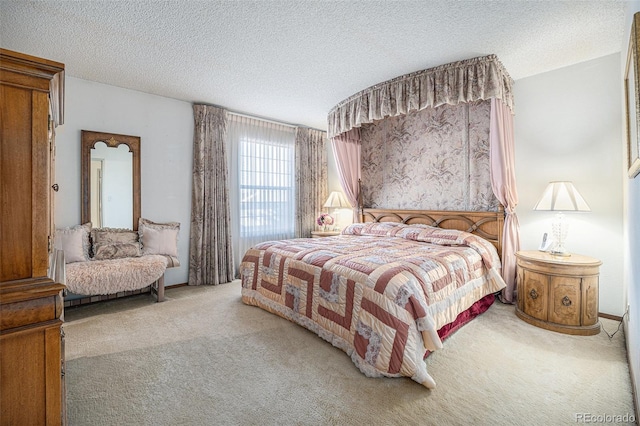 bedroom with light colored carpet and a textured ceiling