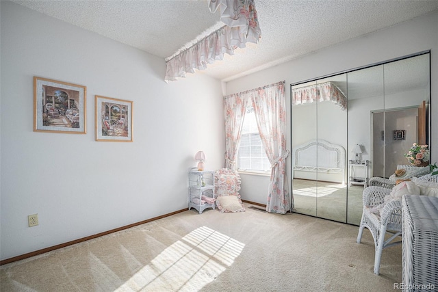 carpeted bedroom with a closet and a textured ceiling