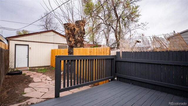 wooden terrace featuring fence