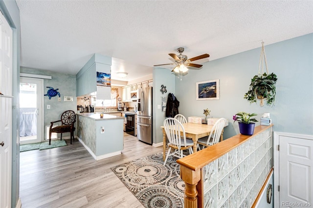 862 Centennial Way, Bennett, CO 80102 - dining area with plenty of natural light, light wood finished floors, ceiling fan, a textured ceiling, and baseboards