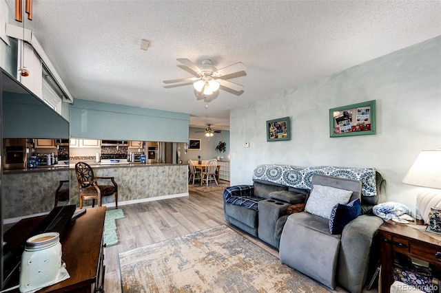 862 Centennial Way, Bennett, CO 80102 - living room with a ceiling fan, wood finished floors, and a textured ceiling