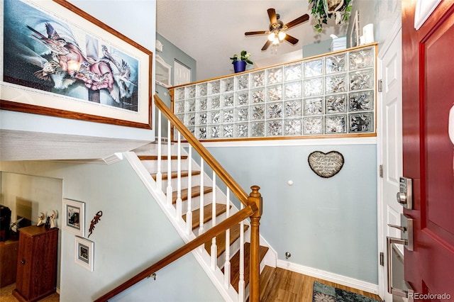 862 Centennial Way, Bennett, CO 80102 - staircase featuring ceiling fan, wood finished floors, and baseboards