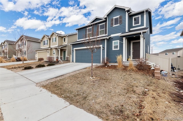 view of front of property with a garage, a residential view, driveway, and fence