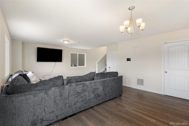 living area featuring stairs, wood finished floors, visible vents, and a notable chandelier