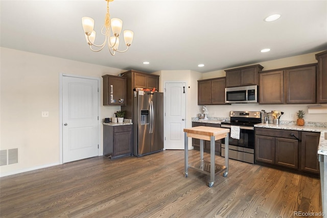 kitchen with dark brown cabinetry, visible vents, appliances with stainless steel finishes, dark wood-style flooring, and recessed lighting